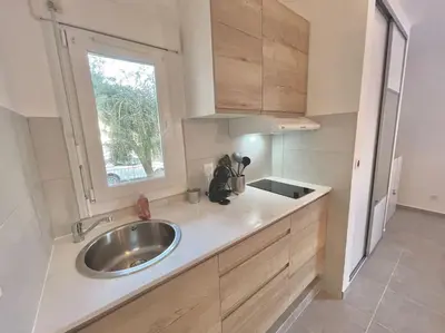 a kitchen with a sink and a window at Appartement Hypercentre Parking Gratuit in Ajaccio