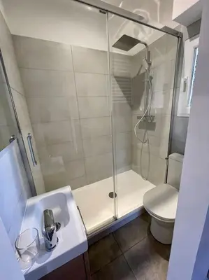 a bathroom with a shower and a sink and a toilet at Appartement Hypercentre Parking Gratuit in Ajaccio