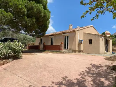 a house with a car parked in front of it at Casa Minnana in Figari