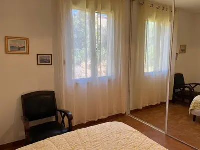 a bedroom with a mirror and a bed and a window at Casa Minnana in Figari