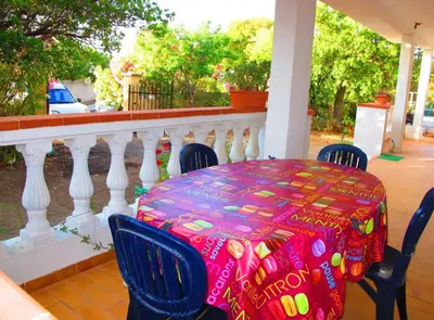 a table with a colorful table cloth on a porch at F1 calme et proche des plages in Coti-Chiavari