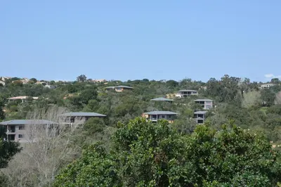 a group of houses on a hill with trees at Les Villas de Lorello in Porticcio
