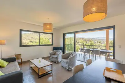 a living room with a couch and a table at Les Villas de Lorello in Porticcio