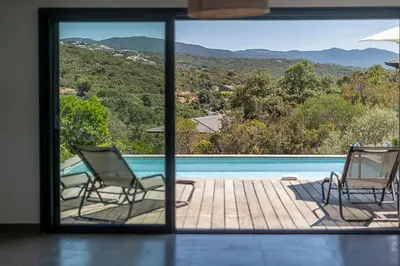 a view of two chairs and a swimming pool at Les Villas de Lorello in Porticcio