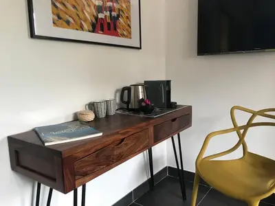 a wooden desk with a coffee maker and a chair at Villa Limone, maison d'hôtes in Calenzana