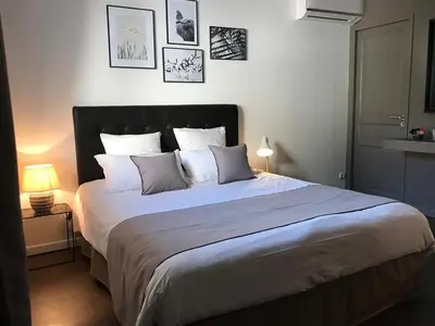 a bedroom with a large bed with pillows at Villa Limone, maison d'hôtes in Calenzana