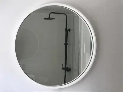a round mirror on a wall with a shower at Villa Limone, maison d'hôtes in Calenzana