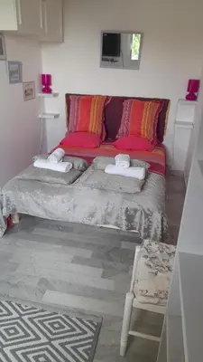 a bedroom with a bed with red pillows at Un Havre de Paix aux Sanguinaires in Ajaccio
