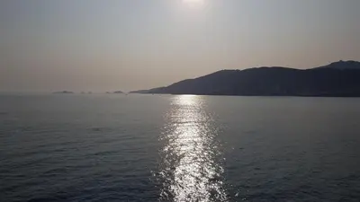 a large body of water with the sun reflecting on it at Un Havre de Paix aux Sanguinaires in Ajaccio