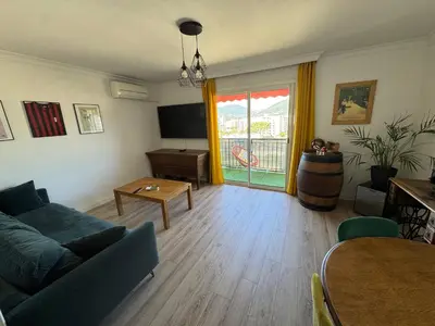 a living room with a couch and a table at T3 Cosy in Ajaccio