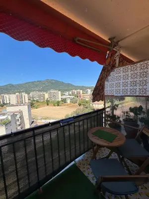 a balcony with a table and chairs and a view at T3 Cosy in Ajaccio