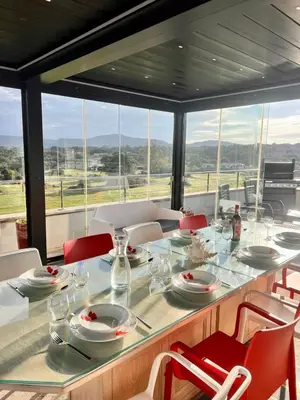 a dining room with a table and chairs with a view at Appart Stella résidence standing, vue panoramique in Porto-Vecchio
