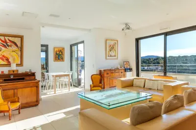 a living room with a couch and a table at Appart Stella résidence standing, vue panoramique in Porto-Vecchio