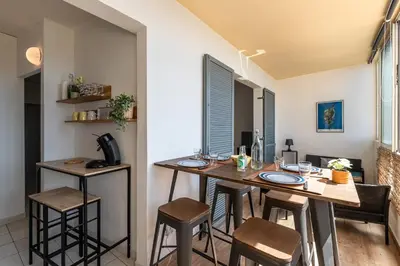 a kitchen and dining room with a table and chairs at Les crêtes , magnifique T2 4 pers Route des Sanguinaires in Ajaccio