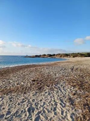 a sandy beach with the ocean in the background at Les crêtes , magnifique T2 4 pers Route des Sanguinaires in Ajaccio