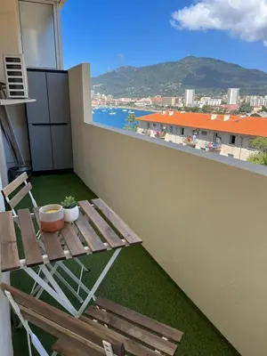 a balcony with a bench and a view of the city at T2 vue mer - entre aéroport et centre-ville in Ajaccio