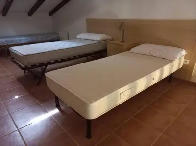 two beds sitting in a room with at Appartement de vacances Marine de Bravone - Corse in Linguizzetta