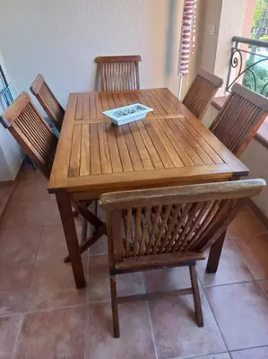 a wooden table with four chairs and a wooden table and chairsktop at Appartement de vacances Marine de Bravone - Corse in Linguizzetta