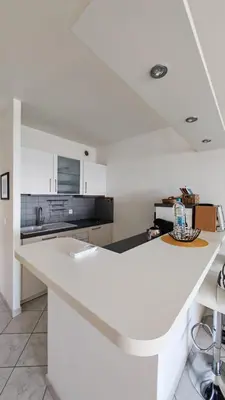 a white kitchen with a white counter top at Superbe Pieds dans l eau ajaccio face à la mer plage de sable fin route des îles des sanguinaires in Ajaccio