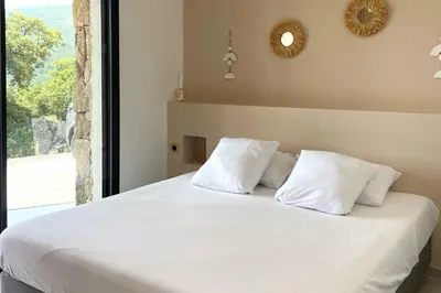 a bedroom with a bed with white sheets and a window at Villa Concarella Di Conca in Conca
