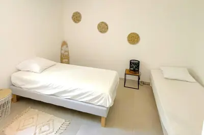 a white bedroom with a bed and a table at Villa Concarella Di Conca in Conca