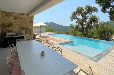 a patio with a table and a swimming pool at Villa Concarella Di Conca in Conca