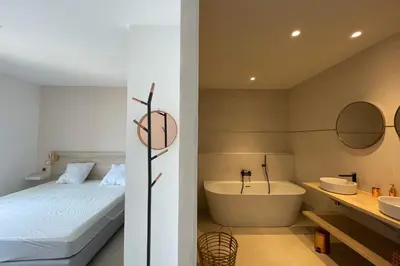 a bedroom with a bed and a tub and a sink at Villa Concarella Di Conca in Conca
