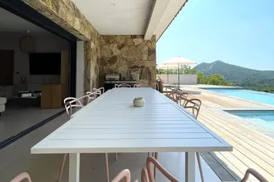 a dining room with a table and a swimming pool at Villa Concarella Di Conca in Conca