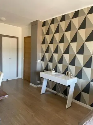 a bathroom with a white table and a geometric wall at Superbe appartement en centre ville in Porto-Vecchio