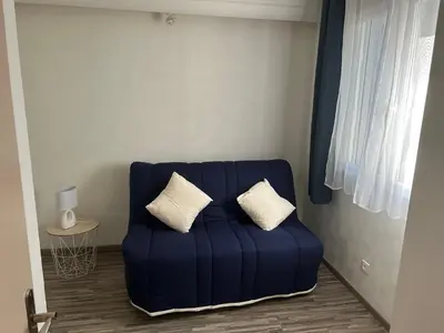 a blue couch with two pillows on it in a room at Entre Mer et Montagne in Venzolasca
