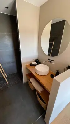 a bathroom with a sink and a mirror at Villa A Licciola in Porto-Vecchio