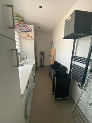 a laundry room with a sink and a washing machine at Villa A Licciola in Porto-Vecchio