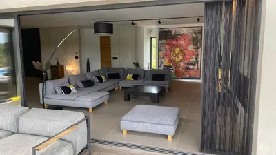 a living room with couches and a couch and a chair at Villa A Licciola in Porto-Vecchio