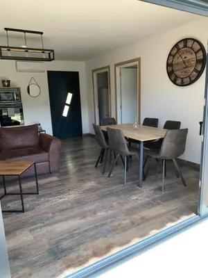 a living room with a table and chairs and a couch at A casetta maison de plain pied in Sartène