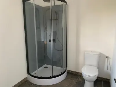 a glass shower in a bathroom with a toilet at A casetta maison de plain pied in Sartène