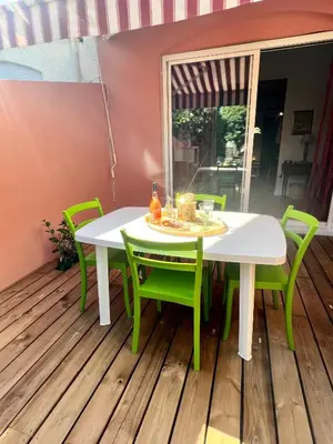 a patio with a table and chairs on a deck at Casa Marana in Borgo