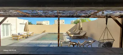 a patio with chairs and a swimming pool at Villa individuelle 3 chambres - 6 pers in Calvi