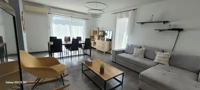 a living room with a couch and a table at Villa individuelle 3 chambres - 6 pers in Calvi