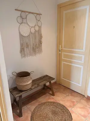 a hallway with a wooden bench and a door at Maison Pinarellu plage à pieds in Zonza