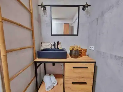 a bathroom with a blue sink and a mirror at Charmant T3 à Porticcio in Porticcio