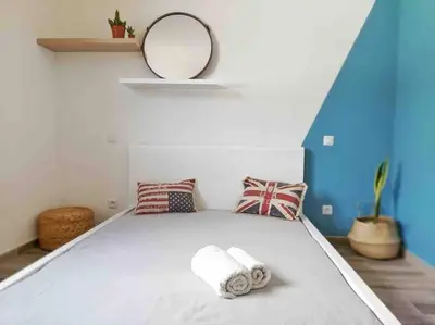 a bedroom with a bed with towels on it at Charmant T3 à Porticcio in Porticcio