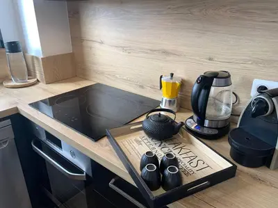 a kitchen with a counter top with a coffee maker and shoes at Charmant T3 à Porticcio in Porticcio