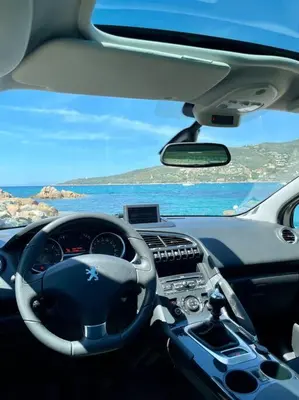 a dashboard of a car with a view of the ocean at Maison en bord de mer in Coggia