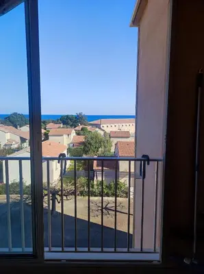 a view from a window of a balcony at A 5 mn à pied de la mer, piscine ,tennis, paillote in Cervione