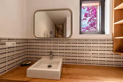 a bathroom with a white sink and a mirror at Villa Valle di Corte - Avec piscine et vue mer in Pianottoli-Caldarello
