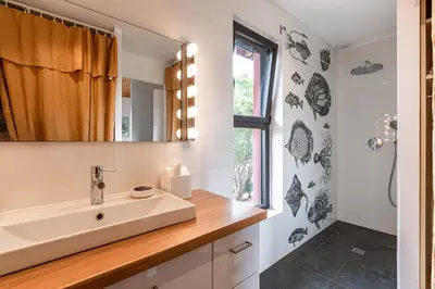 a bathroom with a sink and a mirror at Villa Valle di Corte - Avec piscine et vue mer in Pianottoli-Caldarello