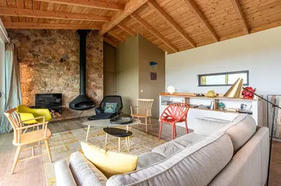 a living room with a couch and a fireplace at Villa Valle di Corte - Avec piscine et vue mer in Pianottoli-Caldarello