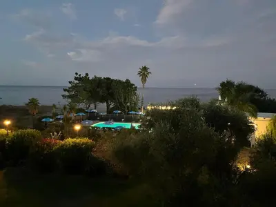 a view of a parking lot with a pool at night at Grand studio les pieds dans l'eau in San-Nicolao