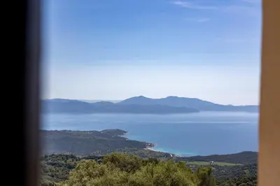 a view of a body of water from a window at Magnifique Bergerie RONDOLINO vue mer et montagne - U Sognu di Paomia in Cargèse