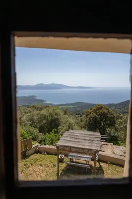 a picnic table with a view of the ocean at Magnifique Bergerie RONDOLINO vue mer et montagne - U Sognu di Paomia in Cargèse